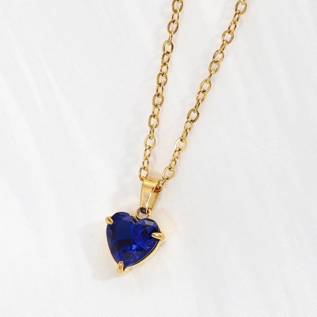 Sapphire blue heart pendant on a gold chain